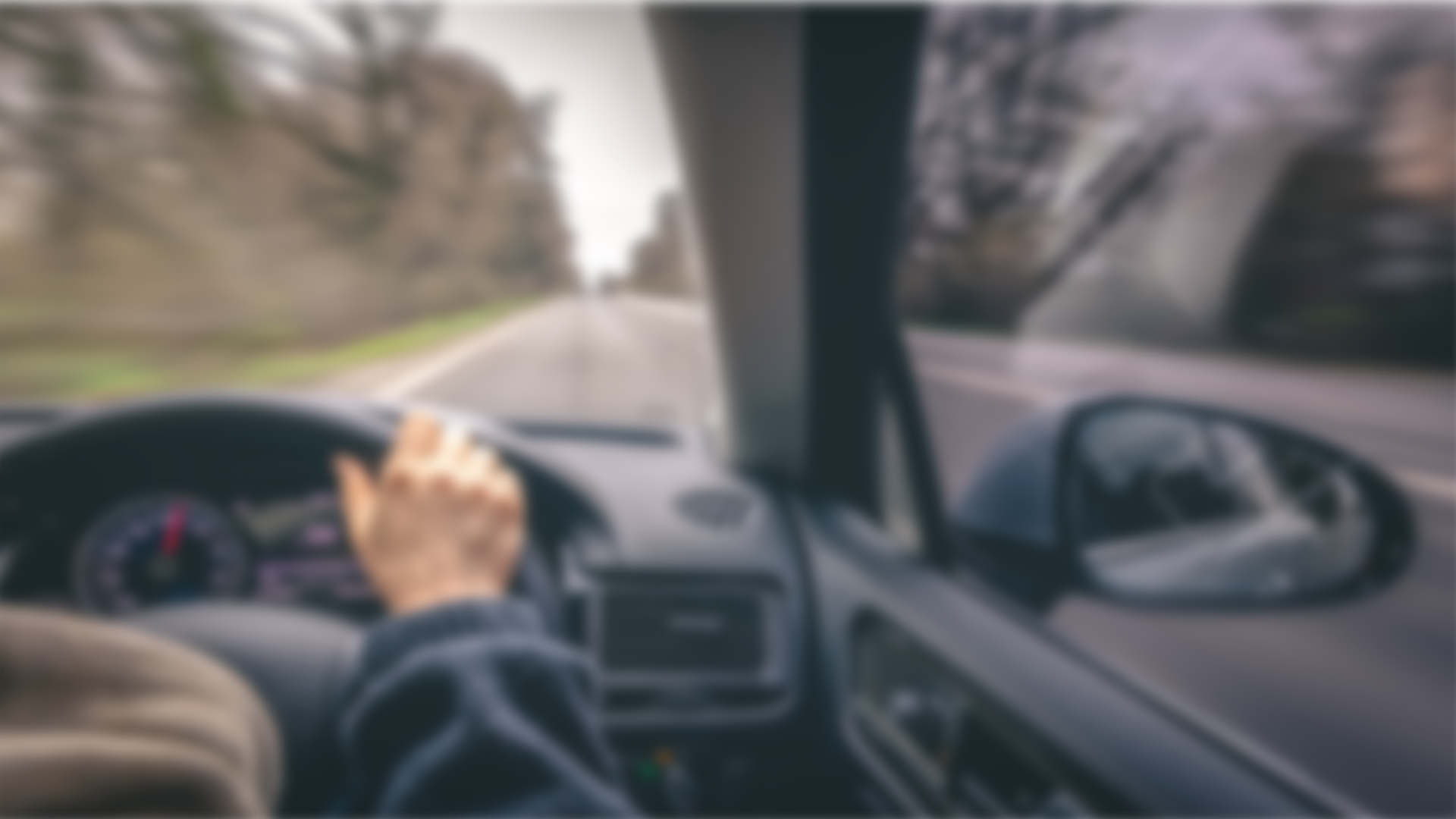 Person driving a vehicle with a blurred background
